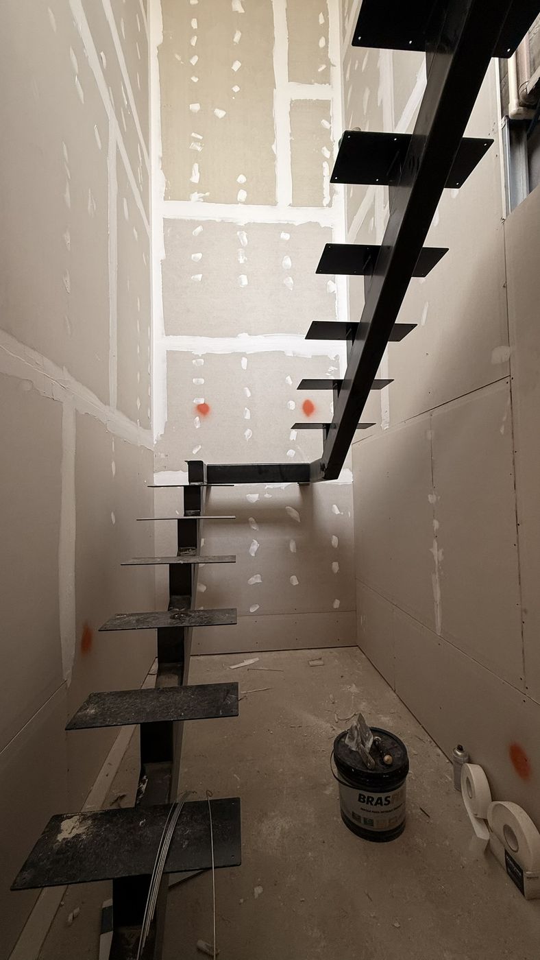 Escada com viga central em aço dentro de caixa de drywall